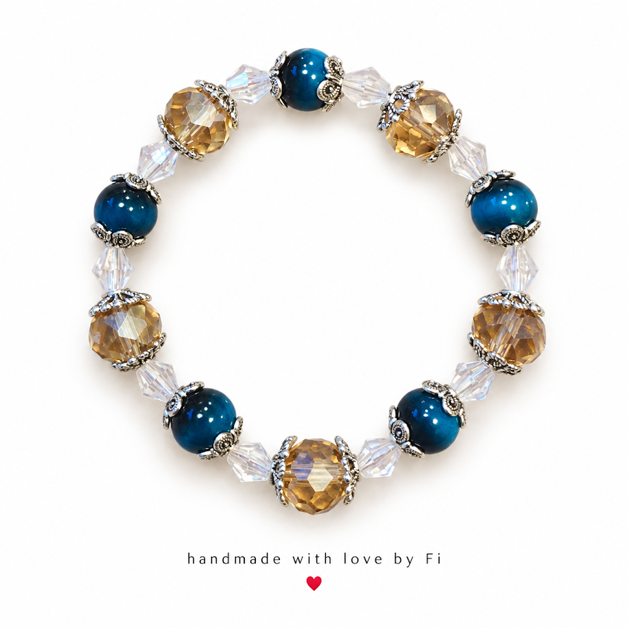 Deep teal and champagne beaded bracelet with clear beads and ornate silver-tone accents