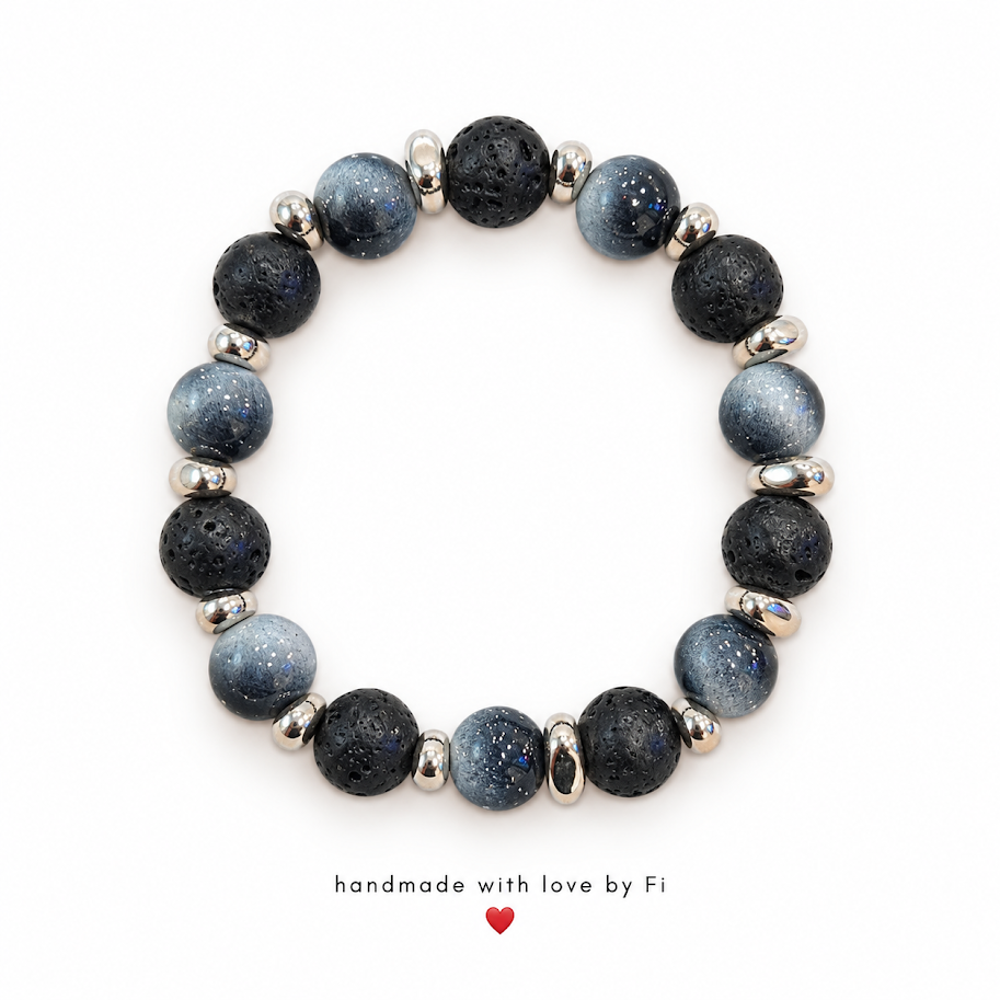 Handmade bracelet with textured black lava-style beads, smoky silver-grey beads and silver-tone spacers
