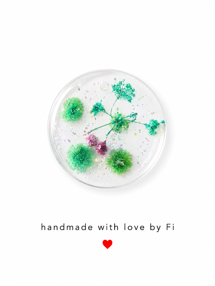 Green and teal botanical resin circle pendant with iridescent glitter handmade by Fi