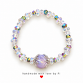 Iridescent beaded bracelet with lavender centre bead and silver-tone accents