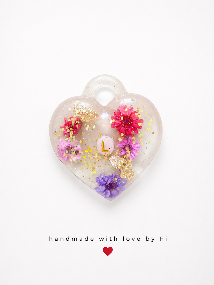 Personalised initial dried flower resin heart pendant with pink lilac and purple flowers gold leaf and glitter handmade by Fi
