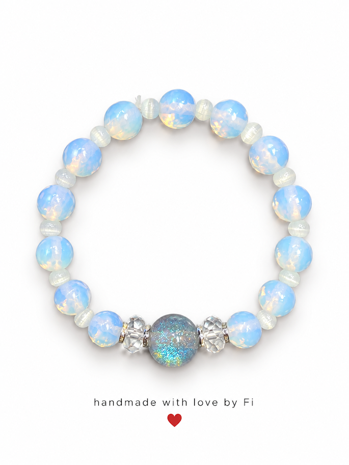 Handmade icy-blue opal-effect beaded bracelet with a glittering centre bead and clear accents