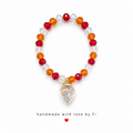 Red orange and clear crystal faceted bracelet with iridescent AB glitter heart globe charm handmade by Fi