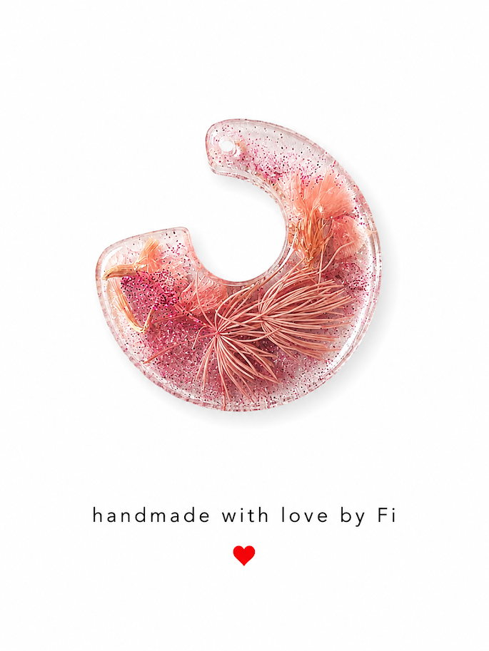 Blush pink glitter resin crescent moon pendant with peach dried grass plumes and rose flower cluster handmade by Fi