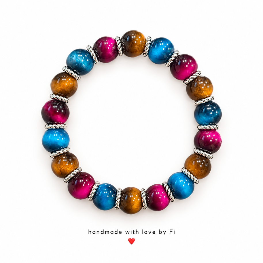 Handmade bracelet with glossy turquoise blue, magenta and amber beads separated by silver-tone spacers