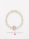 Iridescent AB crystal bicone bracelet with champagne crystal focal bead in silver milgrain bezel handmade by Fi