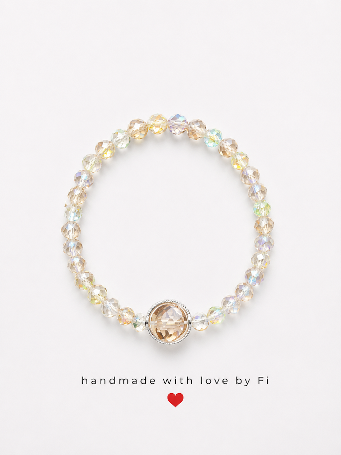 Iridescent AB crystal bicone bracelet with champagne crystal focal bead in silver milgrain bezel handmade by Fi
