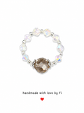 Smoky champagne crystal focal stretch ring with iridescent AB crystal bicones and ornate silver bead caps handmade by Fi