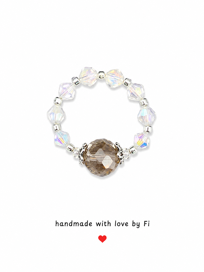 Smoky champagne crystal focal stretch ring with iridescent AB crystal bicones and ornate silver bead caps handmade by Fi