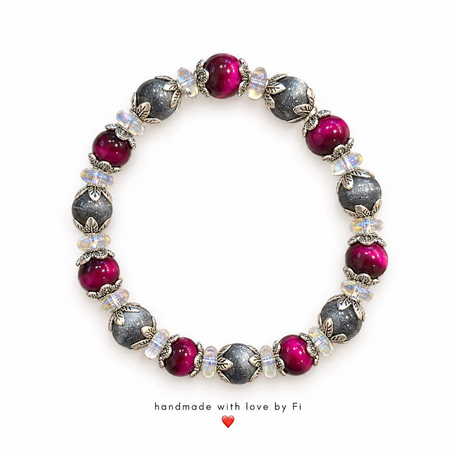 Handmade bracelet with magenta and shimmering charcoal-grey beads, silver-tone floral caps and clear accents