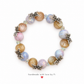 Handmade pastel pink, blue and champagne beaded bracelet with silver-tone butterfly accents