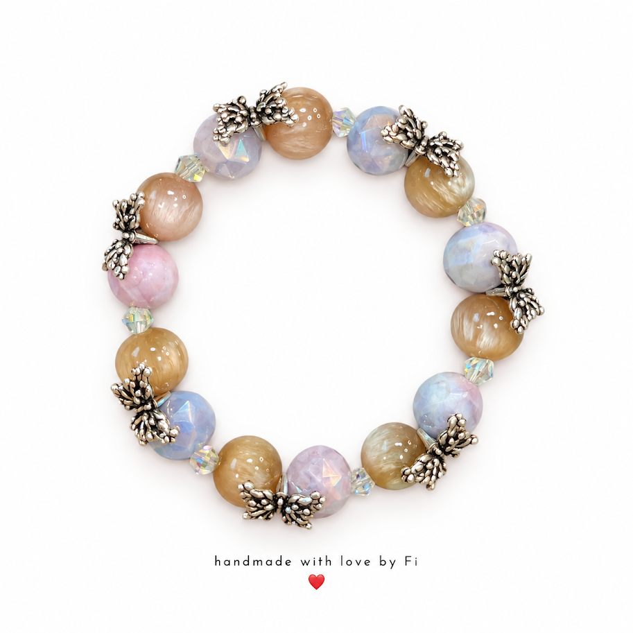 Handmade pastel pink, blue and champagne beaded bracelet with silver-tone butterfly accents