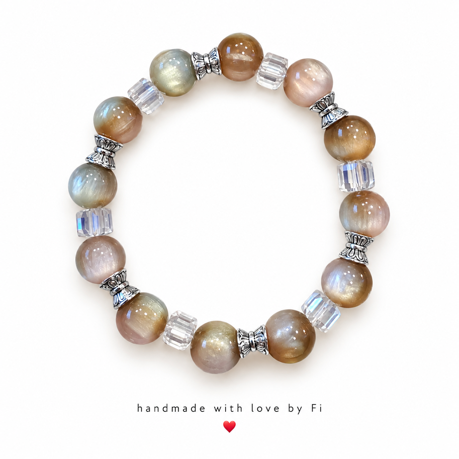 Neutral-toned beaded bracelet with clear cube beads and silver-tone bow spacers