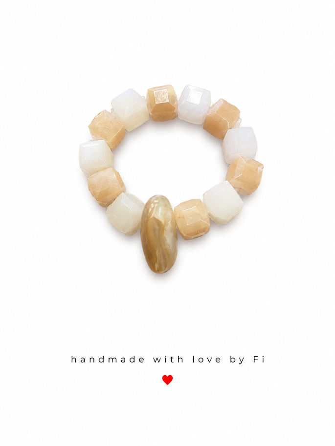 Cream and sandy beige faceted cube stretch ring with large oval golden horn focal bead handmade by Fi