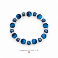 Handmade deep blue bracelet with golden galaxy-effect beads and small pearl-look spacers