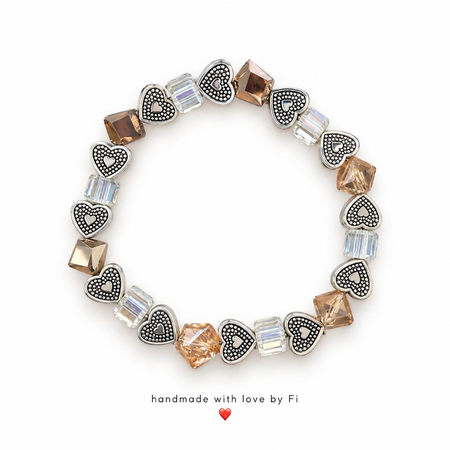 Handmade bracelet with detailed silver-tone hearts, champagne crystals and clear iridescent cube beads